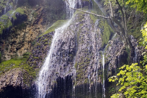 Elevated view of the Urach waterfall flowing over moss-covered rocks, Bad Urach
