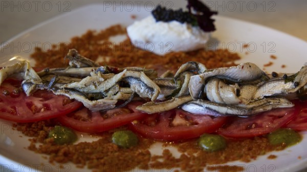 A plate of sardines on tomatoes, stylishly served with various ingredients, Stegna Beach, Stegna viewpoint, Stegna, east coast, Rhodes, Dodecanese, Greek Islands, Greece