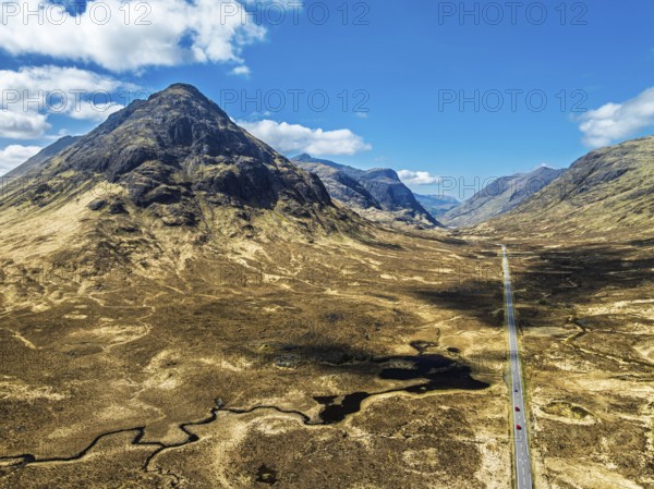 Buachaille Etive Beag and Three Sisters in Glencoe over Moors and Road A82 from a drone, Highlands, Scotland, United Kingdom