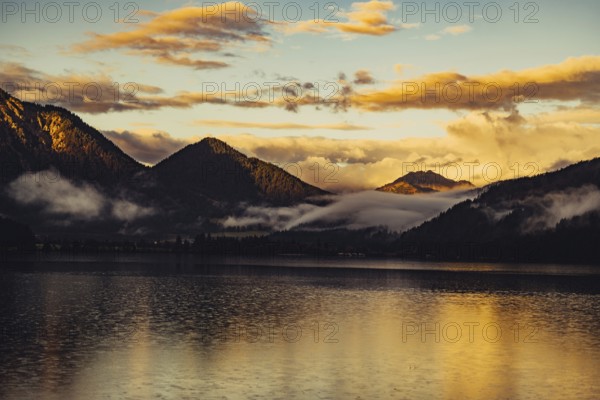 Sunrise with reflections and alpenglow in Lake Heiterwanger See in Tyrol in the Alps in Austria