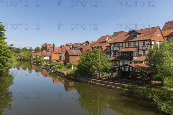 Old fishermen's settlement along the Werra, Bad Sooden, Allendorf, district Allendorf, street Fischerstad under monument protection, half-timbered houses, water reflection, beer garden, trees, blue sky, Werra-Meissner-Kreis, Hesse, Germany