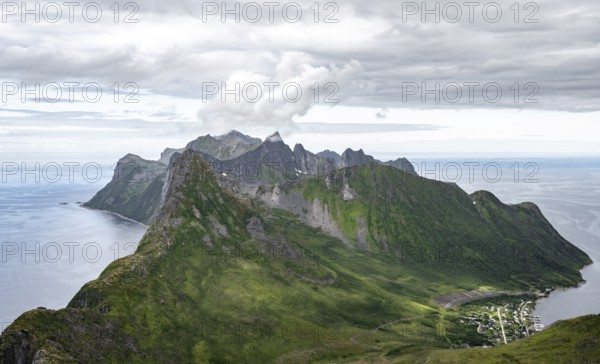 View of mountain peaks on the headland of Fjordgård with peak Segla, fjords Øyfjorden and Mefjorden, view from Barden mountain, Senja, Norway