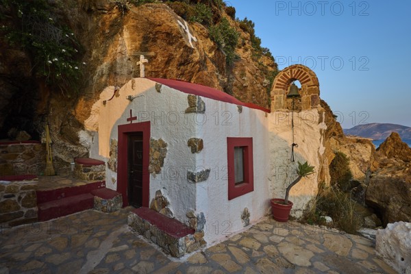 Legend, crab, shell fisherman, rock embedded chapel with cross and bell arch, surrounded by coastal landscape, chapel, small church, Agia Kavouradena Monastery, Xirokambos, Leros, Dodecanese, Greek Islands, Greece