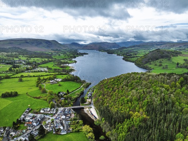 Farms and mountains over Ullswater Lake from drone, Pooley Bridge, Lake District National Park, Cumbria, England, United Kingdom