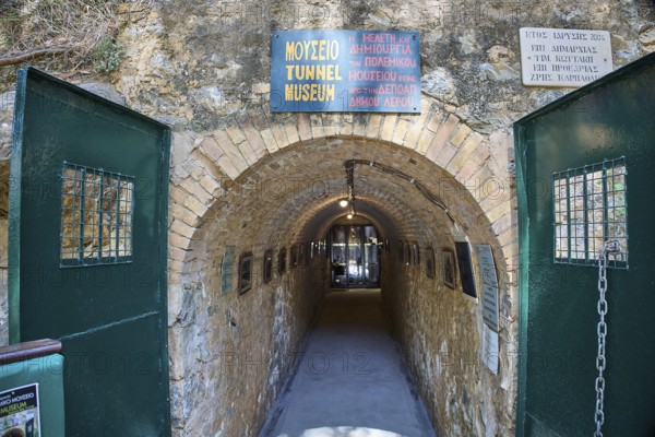 Entrance to a tunnel museum with green doors and several signs, War Museum, Military Museum, Tunnel Museum, Lakki, Leros, WW2, Dodecanese, Greek Islands, Greece