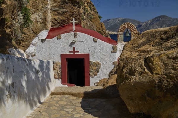 Legend, Crab, Mussel fisherman, Quiet chapel with red and white facade embedded in rocky landscape under blue sky, Chapel, Little church, Monastery Agia Kavouradena, Xirokambos, Leros, Dodecanese, Greek Islands, Greece