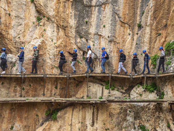 Tourists on the elevated path of the caminito del rey, along a deep gorge, Andalusia, Spain