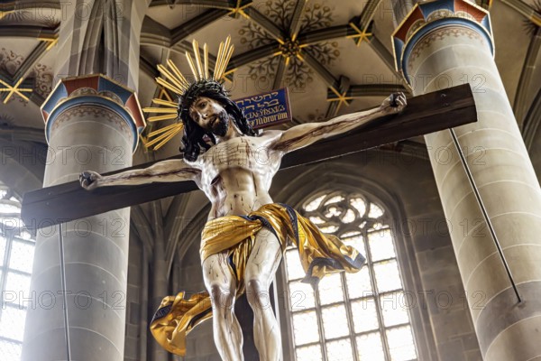 Protestant parish church of St Michael. As Johannes Brenz's place of work, it was the starting point of the Reformation in the territory of the imperial city after 1523. Cross above the high altar. Schwäbisch Hall, Baden-Württemberg, Germany