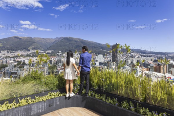 Quito, Ecuador, May 2 2025: Young tourist couple overview Carolina Park modern condominiums in Quito central business financial district