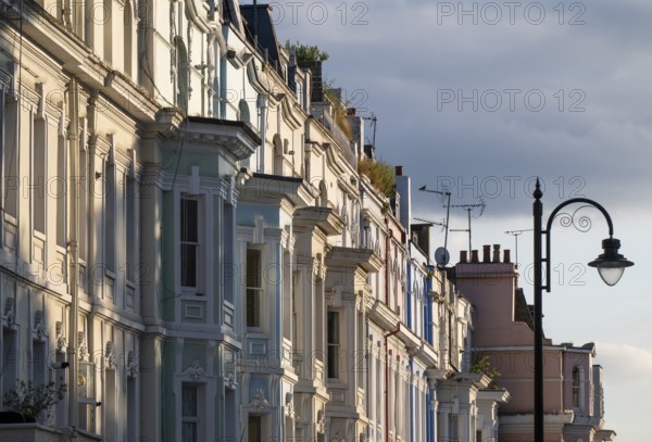 Street lamp, terraced houses, townhouses with different, partly pastel-coloured facades Portobello Road, Notting Hill, London, England, Great Britain