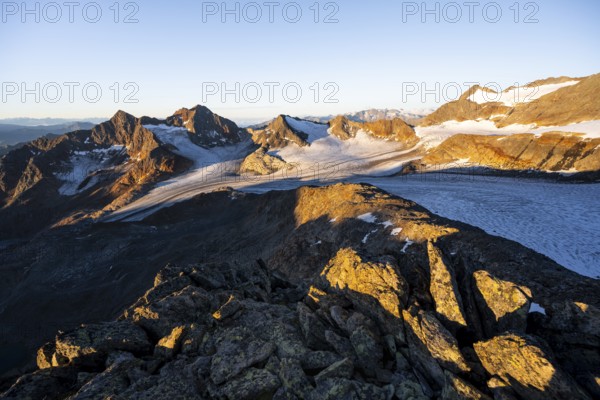 Picturesque high mountain landscape at sunrise with alpenglow, glacier and rocky mountain peaks in the morning light, view at Becher of mountain peaks Königshofspitz and Sonklarspitze and Schwarzwandspitz with glacier Übeltalferner, Stubai Alps, South Tyrol, Italy
