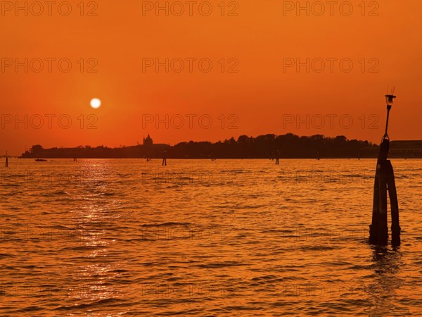 View over the lagoon to Venice at sunset, lagoon city of Venice, Veneto, Italy