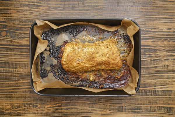 Overhead view of roasted pork neck in a baking tray