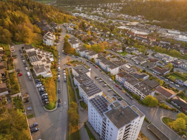 Residential area with streets and buildings in the evening light, surrounded by green nature, Nagold, Black Forest, Germany