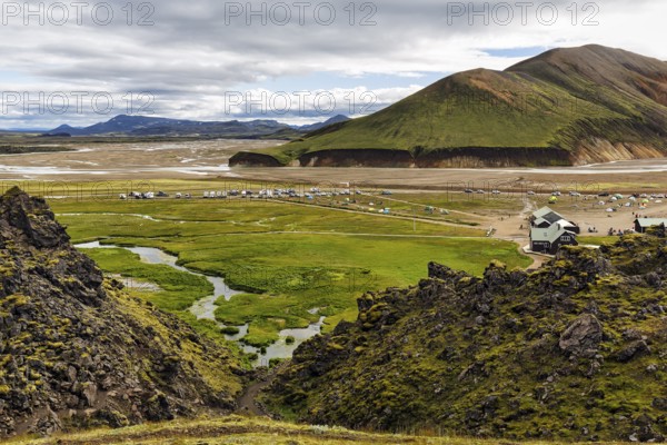 Hiking trail through volcanic landscape, lava rock, view of the campsite in Landmannalaugar, Icelandic highlands, Suðurland, Sudurland, Iceland