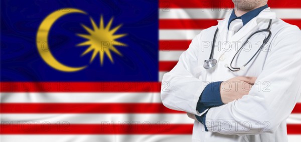 Malaysia healthcare concept. Male doctor on Malaysia flag. Doctor with crossed arms on Malaysia flag