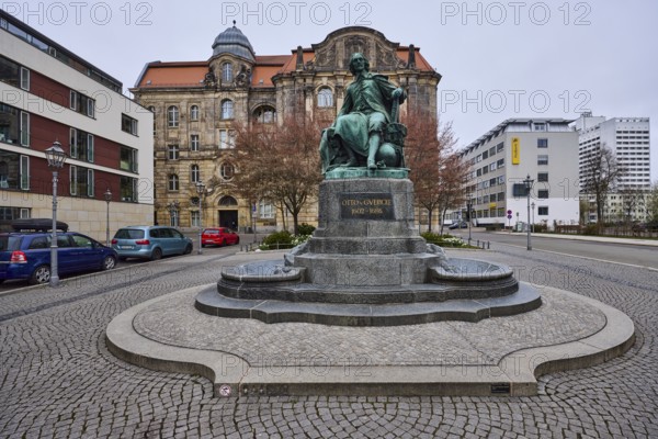 Monument to Otto von Guericke, pavement made of cobblestones, lantern, parking lane with vehicles, sandstone building, public order office, diffuse light, cloudy, street Bei der Hauptwache, Magdeburg, state capital, independent city, Saxony-Anhalt, Germany