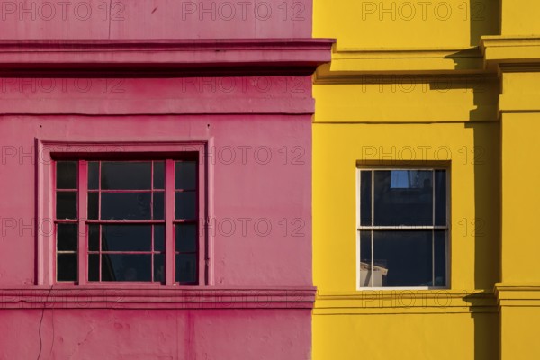 Colourful building facades in pink and yellow, Portobello Road, Notting Hill, London, England, Great Britain