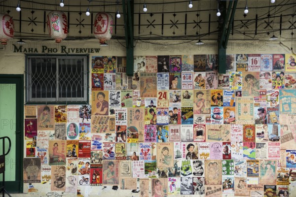 House wall with old posters and advertising, Chinatown, Bangkok, Thailand