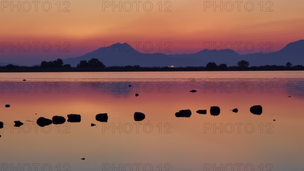 Dusk at the lake with dramatic sky and mountain silhouettes, salt lake, Tigaki, nature reserve, hydro biotope, Kos, Dodecanese, Greek Islands, Greece