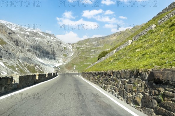 View of east ramp ascent to descent from Alpine pass Stelvio Stilfserjoch mountain road above tree line, with many hairpin bends in the background leading to pass summit of 2757 2758 metres high pass road mountain pass with tight bends hairpin bends Stelvio Stelvio, Stilfs, South Tyrol, Alto Adige, Italy