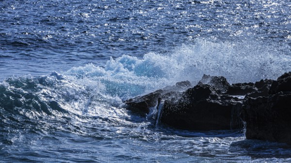 Rugged rocky coastline and foaming spray, on Stecci beach, near Capoliveri, Elba Island, Tuscan Archipelago National Park, Tuscany, Italy
