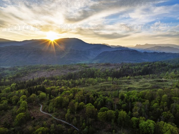 Sunset over Mountains and Coniston Water from drone, Lake District National Park, Cumbria, England, United Kingdom