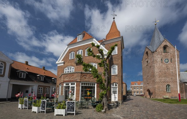 Historic brick building with street café, next to church, Old Town, Ringkøbing, Ringkøbing Fjord, Denmark