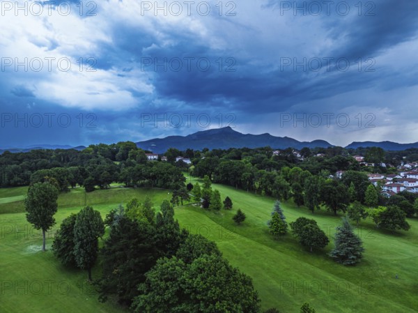 Sunset and storm clouds over Pyrenees and Saint-Jean-de-Luz from a drone, Nouvelle-Aquitaine, Pyrenees-Atlantiques, France
