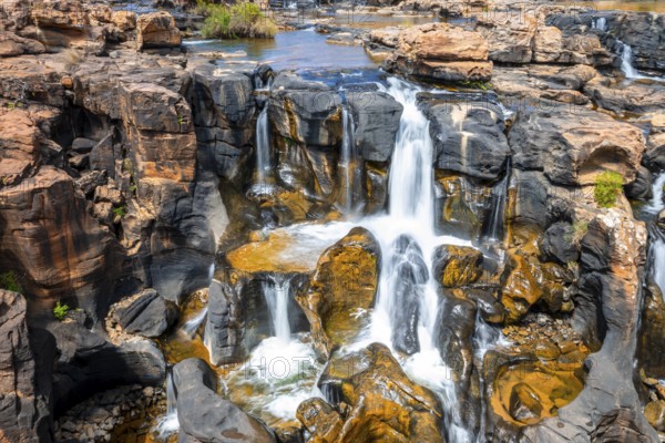 Waterfall on orange-coloured rock cliffs, long exposure, Blyde River, Bourke's Luck Potholes, Panorama Route, Mpumalanga, South Africa