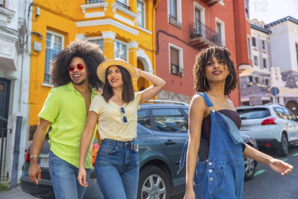 Happy friends enjoying a summer journey together, walking down a vibrant street with colorful buildings