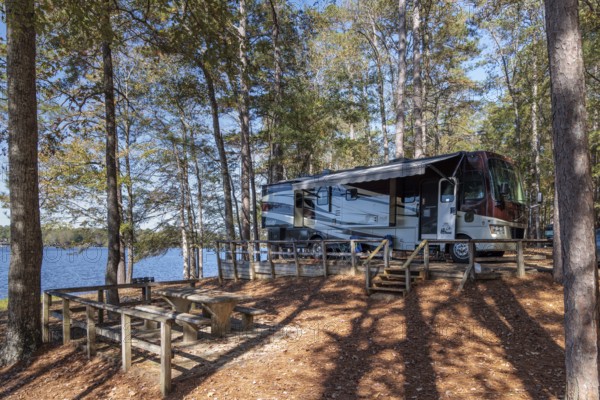 Motorhome parked on the shores of Archusa Creek Lake in Archusa Creek Water Park near Quitman, Mississippi