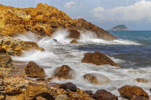 Rugged rocks and foaming spray on Topinetti beach, near Rio Marina, Elba Island, Tuscan Archipelago National Park, Tuscany, Italy