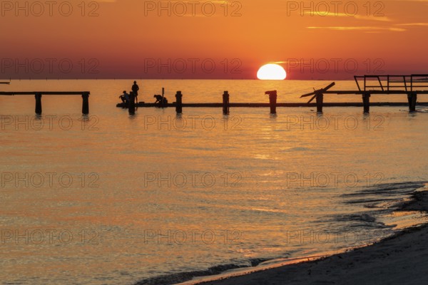 Sunset behind dilapidated fishing pier damaged by hurricanes on the Mississippi Gulf Coast in Long Beach, Mississippi