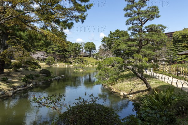 Shukkei-en with green plants, trees and Takuei-chi pond in spring, historical Japanese strolling garden, Japanese garden, green area, tourist attraction, sight, Naka-ku, Hiroshima, Japan