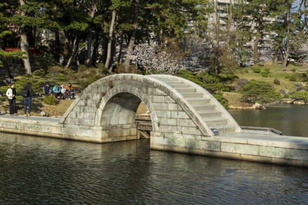 Shukkei-en with Koko-kyo stone bridge over Takuei-chi pond in spring, historical Japanese strolling garden, Japanese garden, green area, tourist attraction, sight, Naka-ku, Hiroshima, Japan