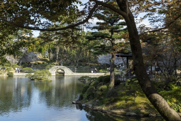 Shukkei-en with Koko-kyo stone bridge over Takuei-chi pond in spring, historical Japanese strolling garden, Japanese garden, green area, tourist attraction, sight, Naka-ku, Hiroshima, Japan