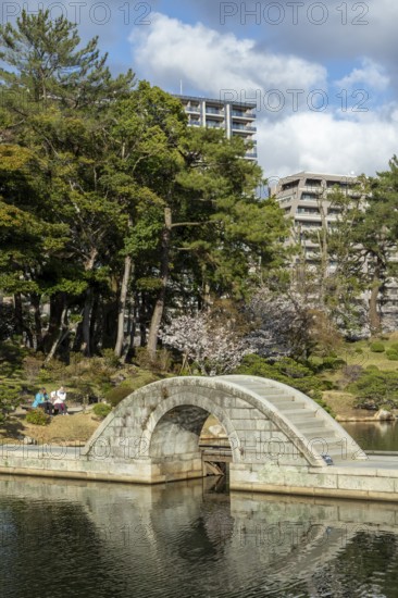 Shukkei-en with Koko-kyo stone bridge over Takuei-chi pond in spring, historical Japanese strolling garden, Japanese garden, green area, tourist attraction, sight, Naka-ku, Hiroshima, Japan