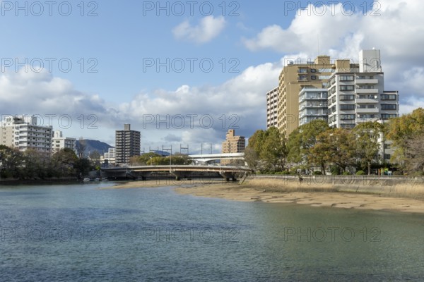 High-rise buildings and bridge over the Kyobashi-gawa River in spring, Naka-ku, Hiroshima, Japan