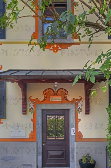 Yellow façade with wooden front door, Dornbirn, Vorarlberg, Austria