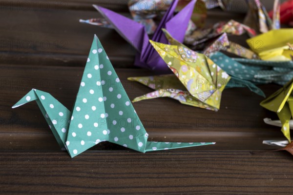 Colourful origami cranes made of paper as a sign of peace in the Peace Park, close-up, landmark, UNESCO World Heritage Site, peace monument and memorial to the victims of the atomic bombing of Hiroshima, Naka Ward, Hiroshima, Japan
