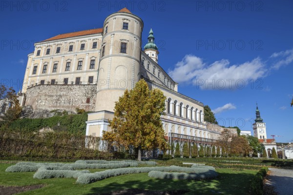 A majestic castle with a well-tended garden stretches out under a clear blue sky, Mikulov Nikolsburg Czech Republic