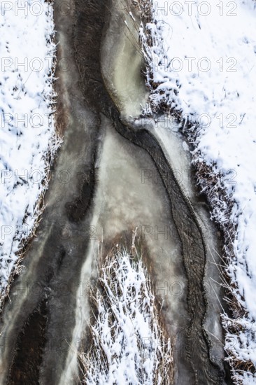 A frozen stream with snow cover in abstract form, Kamptal Waldviertel Austria