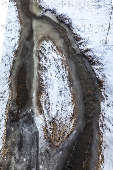 Aerial view of a partially frozen stream surrounded by snow, Kamptal Waldviertel Austria