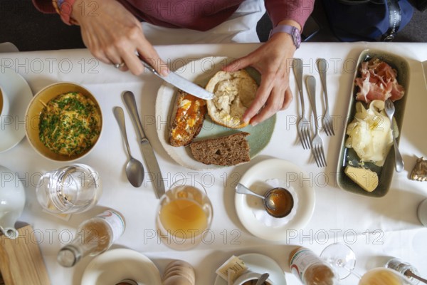 Breakfast table with various dishes served on a plate by someone with cutlery, Lower Austria Austria