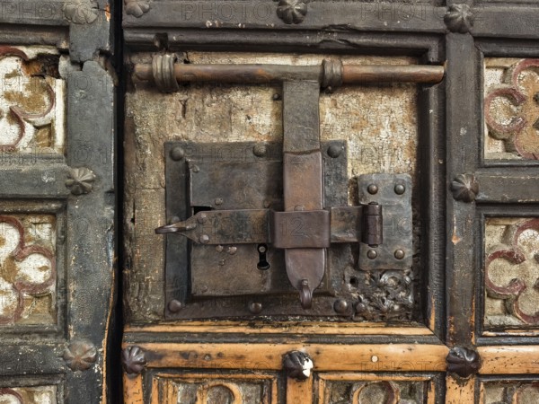 An old, rustic lock system on a wooden and decorated door, Lower Austria Austria