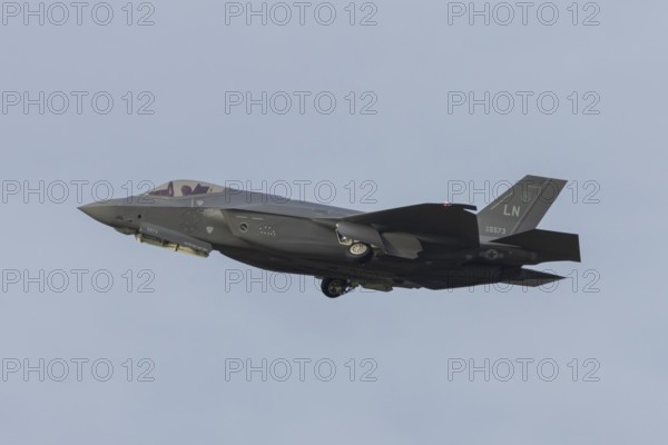 Lockheed Martin F-35 Lightning II fighter military aircraft of the United States air force USAF taking off in flight at RAF Lakenheath airbase, Suffolk, England, United Kingdom