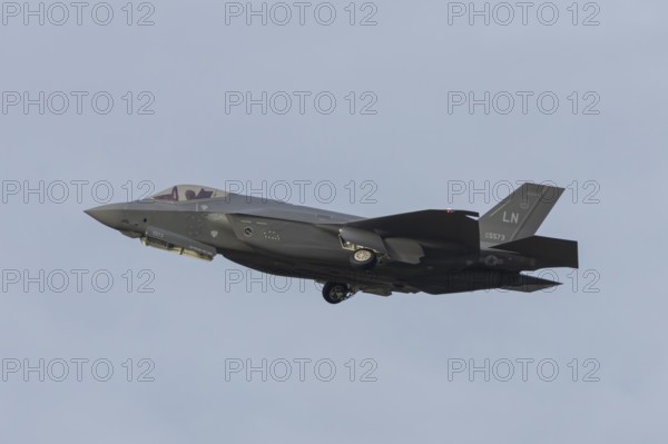 Lockheed Martin F-35 Lightning II fighter military aircraft of the United States air force USAF taking off in flight at RAF Lakenheath airbase, Suffolk, England, United Kingdom