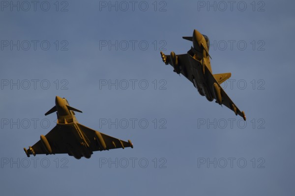 Eurofighter Typhoon two military fighter jet aircraft of the Royal air force RAF flying in formation, England, United Kingdom