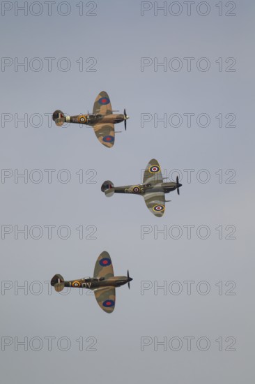 Supermarine Spitfire three warbird military aircraft in Royal air force RAF colours flying, England, United Kingdom